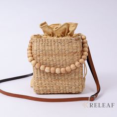 "- New Collection -  🎗This lovely wicker straw bucket crossbody bag features come with a bamboo beads top handle used as a tote or shoulder bag by attaching a brown crossbody faux crossbody strap.  🎗The cotton inner lining and a small pocket inside. Size : (Width) 6 x (Length) 7 x (Thickness) 6 Inches          🎗Item Overview:  ▫️Processed: Handmade ▫️Material: Hyacinth straw.  ▫️Inner lining: 100% cotton natural dyed color. ▫️Each bag is individually handwoven. ▫️Weight: 250 grams 📌 Note: \" This bag is handcrafted by locals, there may be slight variations in dimensions, color, and texture \"  ☀️ THIS BAG LOVES SUNSHINE ☀️ The easiest way to take care of this bag by dry out in the sun often, avoid humidity and water.  📌 I accept personalized sizes and designs, the processing takes abo Summer Shoulder Bucket Bag As Gift, Beige Crossbody Straw Bag As Gift, Straw Shoulder Bag With Braided Handles For Gift, Summer Gift Bucket Shoulder Bag, Gift Straw Shoulder Bag With Braided Handles, Natural Straw Shoulder Bag Gift, Natural Straw Shoulder Bag For Gift, Natural Straw Crossbody Bag As Gift, Natural Color Crossbody Straw Bag As Gift