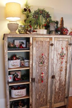 an old wooden cabinet with christmas decorations on it