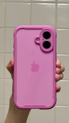 a person holding up a pink iphone case