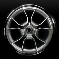 the spokes and tires of a car are shown in this black background, with only one tire visible