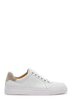 White shoes always add a fresh and clean look to an outfit. This leather sneaker is sporty yet classy with contrasting suede details and sleek silhouette.Sizing: True to size. Round toe. Leather construction. Suede heel detail. Lace-up closure. Padded footbed. White sole. Imported White Sports Sneakers With Stitched Sole, White Suede Casual Custom Sneakers, White Suede Casual High-top Sneakers, White Sneakers With Stitched Sole And Round Toe, Casual White Sneakers With Stitched Sole, White Leather Platform Sneakers For Light Sports, White Leather Platform Sneakers For Casual Sports, Custom White High-top Sneakers With Stitched Sole, White Casual Platform Sneakers With Stitched Sole