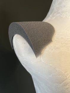 the back end of a white dress with lace on it