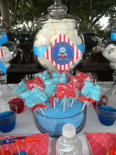 there is a bowl full of marshmallows on the table with other treats