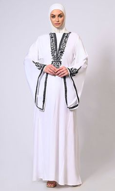 White Abaya with Bell Sleeves adorned in Hand & Machine Embroidery - EastEssence.com Long Sleeve Abaya With Intricate Embroidery For Eid, Long Sleeve Thobe With Intricate Embroidery For Eid, Eid Long Sleeve Abaya With Intricate Embroidery, Eid Thobe With Intricate Embroidery Long Sleeve, Eid Thobe With Intricate Embroidery, Modest Long Embroidered Kaftan, Elegant Floor-length Thobe With Floral Embroidery, Elegant Long Sleeve Thobe With Floral Embroidery, Elegant Long Sleeve Abaya With Intricate Embroidery