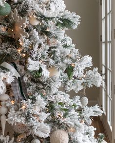 a christmas tree with white and green ornaments