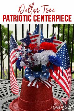 a patriotic centerpiece with red, white and blue flowers in it on top of a table