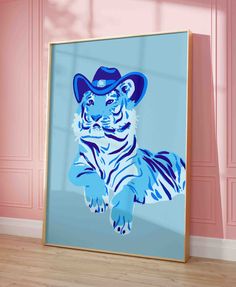 a blue and white tiger wearing a cowboy hat in front of a pink wall with wood flooring