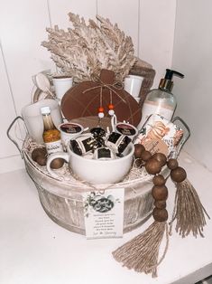 a basket filled with lots of different items on top of a white counter next to a bottle