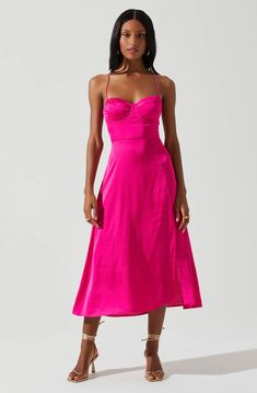 a woman in a bright pink dress