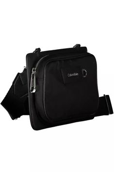 Elevate your accessory game with the Calvin Klein Shoulder Bag, where functionality meets urban chic. Crafted from premium materials, 95% Polyester and 5% Polyethylene, this sleek black bag is a testament to Calvin Klein’s commitment to eco-conscious fashion with 60% recycled polyester. It features an adjustable and removable strap for versatile styling, an external pocket for easy access, and signature contrasting details that highlight the brand’s eye for design. Zip closure secures your belon Modern Black Camera Bag, Modern Black Camera Bag With Zipper Pocket, Functional Nylon Shoulder Camera Bag, Trendy Black Bags For Commuting, Modern Calvin Klein Shoulder Bag With Zipper Closure, Casual Nylon Business Bag, Trendy Nylon Bags For Commuting, Functional Nylon Camera Bag With Removable Pouch, Business Nylon Shoulder Bag With Adjustable Strap