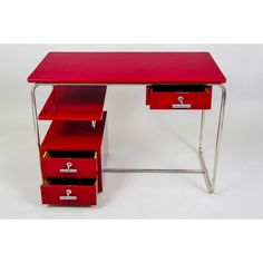 a red desk with three drawers on it