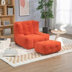 an orange chair and ottoman in a living room