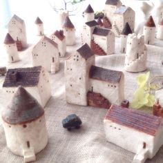 small ceramic houses are sitting on a table