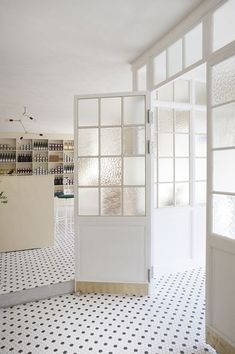 the interior of a nail salon with black and white tiles on the floor, walls and floors