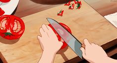 a person cutting tomatoes with a large knife