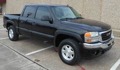 a black pickup truck parked in a parking lot