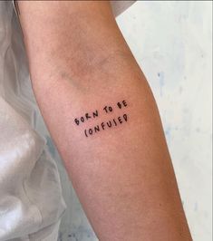 a woman's arm with the words born to be confuity written on it