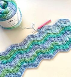 a crochet pattern next to a ball of yarn