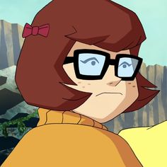 an animated image of a woman with glasses and a bow in her hair looking at the camera