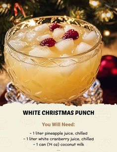 white christmas punch recipe in a glass bowl with ice and raspberries on top