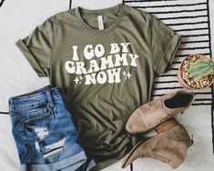 i go by gram mix now shirt next to some shoes and cactus in a pot