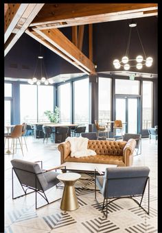 a living room filled with furniture and lots of windows