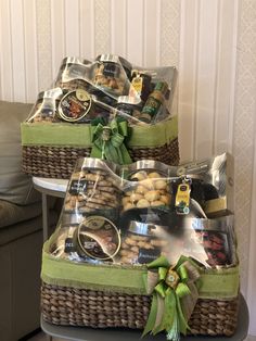 two wicker baskets filled with food on top of a table next to a couch