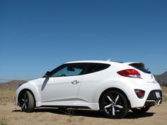 a white sports car parked in the desert