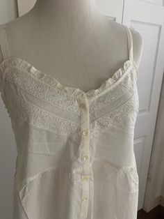 Gorgeous vintage cotton nightgown by Victoria's Secret Country.  NWT!  Extra button included too! Tagged size medium Straps adjust Note dark discoloration on one strap in photos! Lace border at bottom Smocking is stretchy at back No issues other than strap Bust flat back is 13-14 inches Stretches to 18 inches approximately Length is 48 inches Summery gown! Final sale. No returns. Sold as is. Summer Vacation Nightgown With Lace Trim, Summer Nightgown With Lace Trim, Summer Nightgown With Spaghetti Straps And Lace Trim, Summer Sleeveless Nightgown With Delicate Lace, Summer Sleeveless Delicate Lace Nightgown, Summer Beach Nightgown With Lace Trim, Sleeveless Delicate Lace Summer Nightgown, Summer Camisole Nightgown With Lace Trim, Summer Nightgown With Delicate Lace For Loungewear