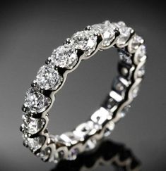 a white gold ring with five diamonds on it