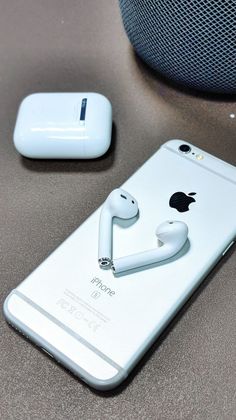 an iphone with ear buds attached to it