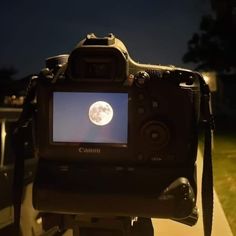 a camera with a full moon in the background