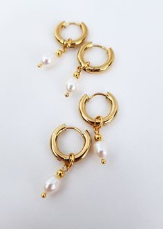 Mini hoop earrings with small pearl charm! These dainty freshwater baroque pearl earrings are perfect addition to you jewelry collection. Mixing all time favorite - hoops and all time classic -pearls, makes these earrings both- beautiful and timeless! It's definitely a must have! You also can take off pearl charms and have plain hoops earrings when needed! Check other pearl earrings here - https://www.etsy.com/shop/GinandJewelryShop?section_id=32608833 Message me if you need larger quantity than Delicate Dangle Hoop Earrings With Pearl Charm, Dainty Pearl Chain Hoop Earrings As Gift, White Gold Plated Hoop Pearl Earrings, Everyday Pearl Charm Dangle Huggie Earrings, Dainty Huggie Pearl Earrings With Charm, Delicate Gold Huggie Earrings With Pearl Charm, Gold Pearl Drop Cartilage Earrings, Gold Delicate Huggie Earrings With Pearl Charm, Gold Pearl Drop Cartilage Earrings As Gift