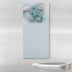 an abstract painting on the side of a stainless steel refrigerator with a white door and handle