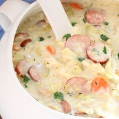 a close up of a bowl of food with meat and vegetables in the broth