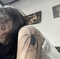 a woman with a spider tattoo on her arm