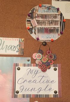 a bulletin board with magnets and other items attached to it, along with a sign that says my creative jungle