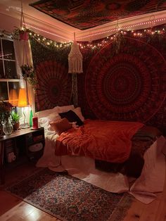 a bedroom with lights strung from the ceiling and a large tapestry hanging over the bed