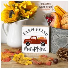 a wooden sign that says farm fresh pumpkins next to fall leaves and sunflowers