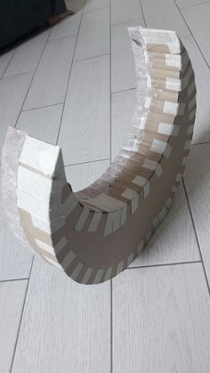 a wooden bench sitting on top of a white tile floor