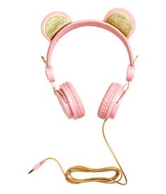 a pair of pink headphones with gold ears on top of each ear and a cord