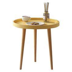 a small table with a plate on it and some sticks sticking out of the top