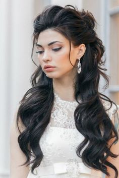 a woman with long black hair wearing a white dress