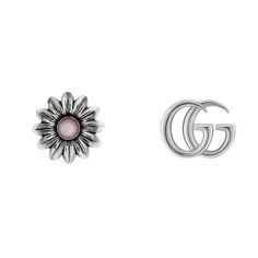 From Gucci, the natural beauty of the botanic world continues to act as a rich source of inspiration for their designs. Crafting from precious sterling silver, one of these petite studs is interpreted as the Double G and the other as a delicate flower with mother of pearl center. 925 sterling silver with aged finish Double G on one earring Flower with pink mother of pearl on one earring 1 pearl, totaling approximately 0.25 carats 12.7mm in diameter Gucci Earrings, Designer Silver Jewellery, Gucci Jewelry, Floral Studs, Mother Of Pearl Earrings, Gucci Gg Marmont, Flower Stud Earrings, Earrings Flower, Gg Marmont