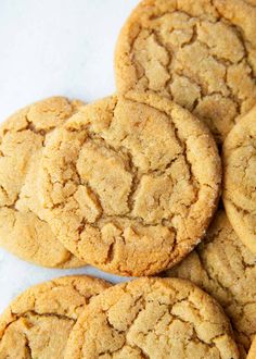 a pile of cookies sitting on top of a white countertop next to each other