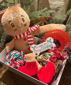 a teddy bear in a christmas gift box