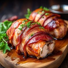 bacon wrapped chicken on a cutting board with garnish