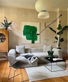 a living room filled with furniture and plants