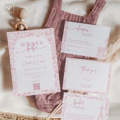 the wedding stationery is laid out on the bed