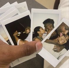 a person holding up four polaroid photos with the same image on them as if they were kissing